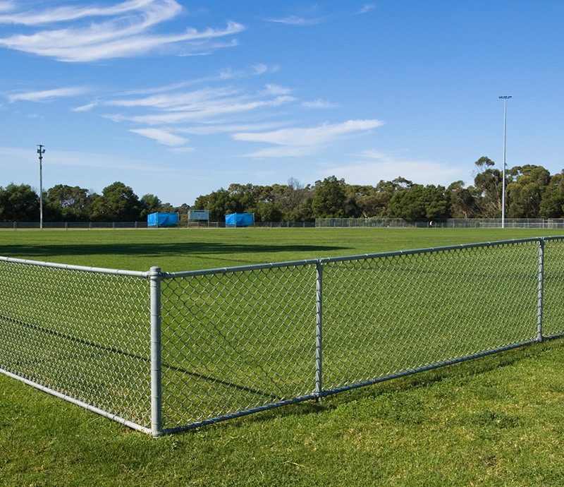 Chain-link fence installed around a sports field