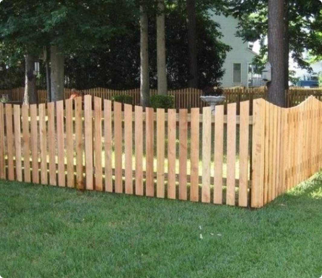 Wooden scalloped picket fence